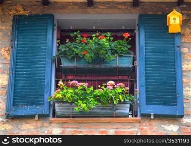 Typical Italian Window With Open Wooden Shutters, Decorated With Fresh Flowers