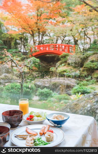Typical Japanese breakfast with japanese garden with white stone and green plant, Japanese cuisine