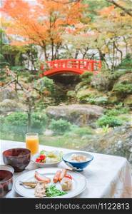 Typical Japanese breakfast with japanese garden with white stone and green plant, Japanese cuisine
