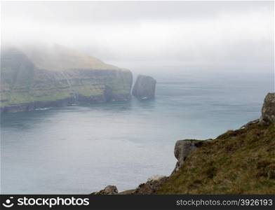 Typical landscape on the Faroe Islands, with green grass and cliffs on the northern edge of streymoy