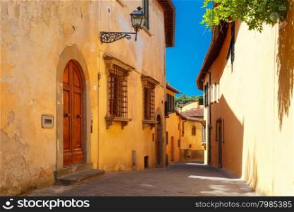 Typical narrow roman street of old town in sunny summer day, Florence, Tuscany, Italy
