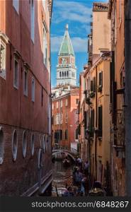 Typical Narrow Street in Venice and St. Marks Bell Tower - Campanile in Background Venice, Italy