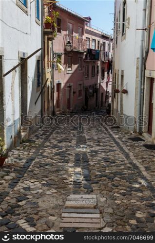 Typical Narrow Street with Cobblestone Floor in Portugal