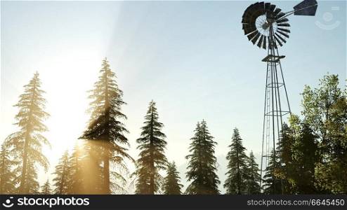 Typical Old Windmill turbine in forest at sunset