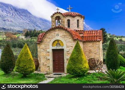 Typical orthodox greek churches surrouded by high mountains. Crete island. Greece