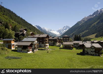 typical Switsch houses with the mountains and snow as a background