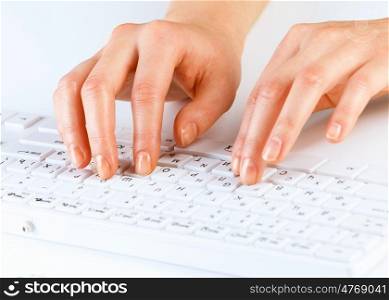 Typing work. Close up of female hands typing on keyboard