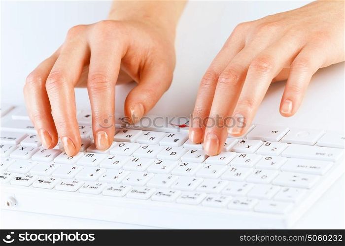Typing work. Close up of female hands typing on keyboard