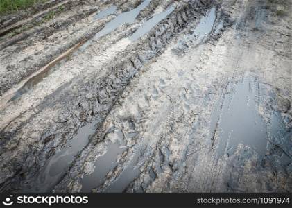 Tyre wheel track on muddy dirt road drive on soil
