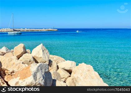 Tyrrhenian sea bay, San Vito lo Capo beach with clear azure water, north-western Sicily, Italy. People unrecognizable.