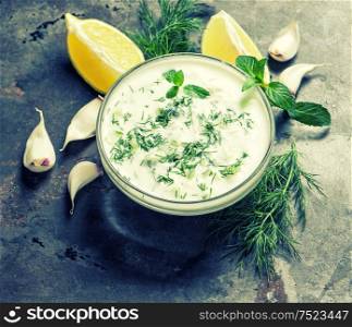 Tzatziki sauce. Fresh dip with herbs dill and mint. Vintage style toned