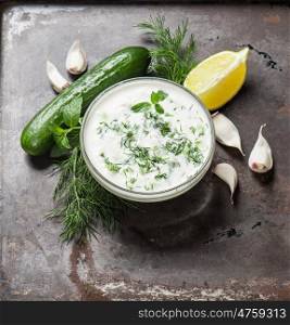 Tzatziki sauce with herbs and vegetables. Food background