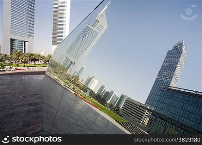 UAE, Dubai, reflection in a mirrored piece of artwork on display at the Dubai International Financial Centre