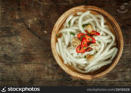 udon noodle in wood bowl on wooden floor background