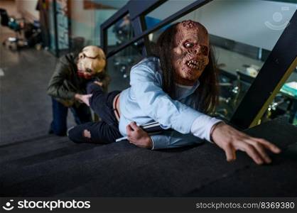 Ugly creepy zombie workers fighting on office staircase. Business challenge contest or competition, rivalry or conflict, effort concept. Zombie workers fighting on office staircase