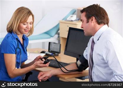 UK doctor taking patient&acute;s blood pressure
