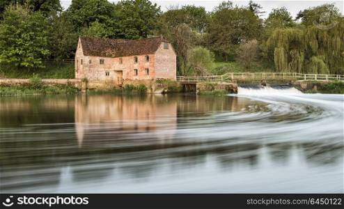 UK. Early morning view across River Stour to Sturminster Newton Mill in Dorset.