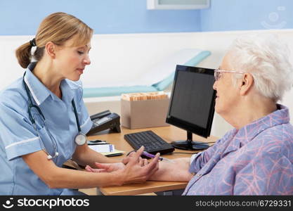 UK nurse injecting senior woman patient