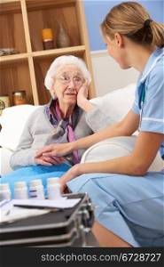 UK nurse visiting senior woman at home