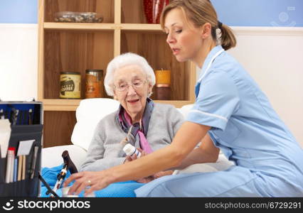 UK nurse visiting senior woman at home