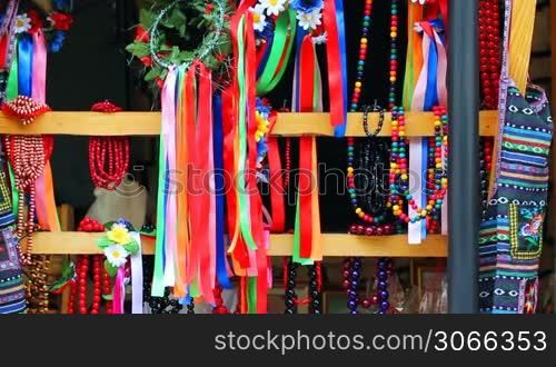 Ukrainian folk ornaments on market, wind sways colored ribbons