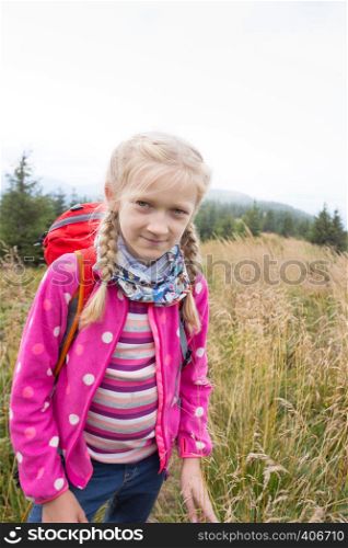 Ukrainian landscape. happy smiling girl child at the mountains in Carpathians, Ukraine
