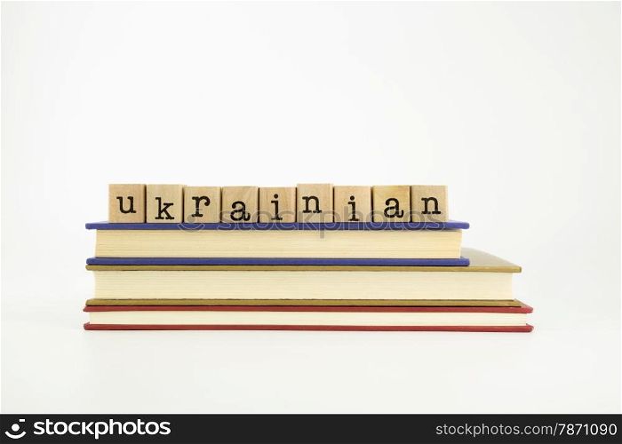 ukrainian word on wood stamps stack on books, language and conversation concept