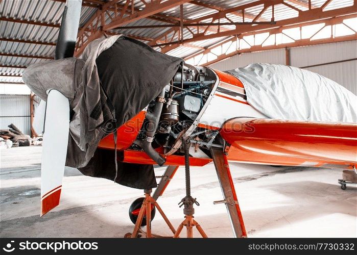 Ultralight small private aircraft airplane on repair in the hangar at the aerodrome airport. Ultralight small private aircraft airplane