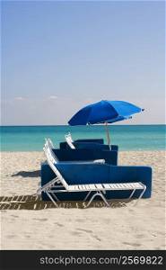 Umbrella and a lounge chair on the beach