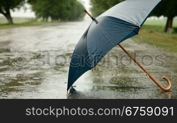 Umbrella On The Road Under Rain