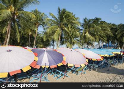 Umbrellas and deck chair at the Bang Saen Beach at the Town of Bangsaen in the Provinz Chonburi in Thailand. Thailand, Bangsaen, November, 2018. THAILAND CHONBURI BANGSAEN BEACH
