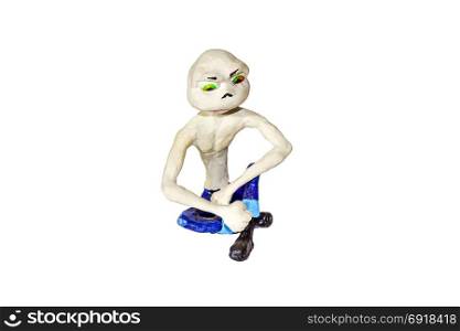 Umorik in sitting posture. Figurine of a skinny character with a large head. Molded from clay and clay. Umorik in sitting posture. Figurine of a skinny character with a large head. Molded from clay and clay.