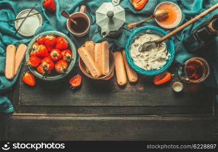 Unadulterated italian strawberry tiramisu cooking ingredients on dark rustic kitchen table, top view, place for text. Italian food concept, border
