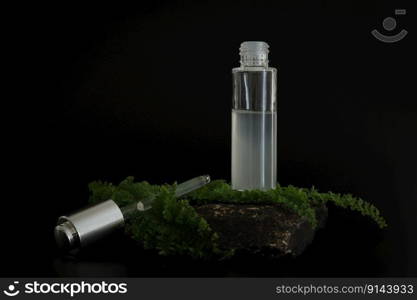 Unbranded natural cosmetic serum packaging standing on stone podium. Serum presentation on the black background. Mockup. Trending concept in natural materials. Natural cosmetic, skincare. Unbranded natural cosmetic serum packaging standing on stone podium. Serum presentation on the black background. Mockup. Trending concept in natural materials. Natural cosmetic, skincare.