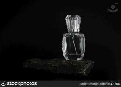 Unbranded perfume bottle standing on stone podium. Perfume presentation on the black background. Mockup. Trending concept in natural materials. Women&rsquo;s and men&rsquo;s essence. Natural cosmetic. Unbranded perfume bottle standing on stone podium. Perfume presentation on the black background. Mockup. Trending concept in natural materials. Women&rsquo;s and men&rsquo;s essence. Natural cosmetic.