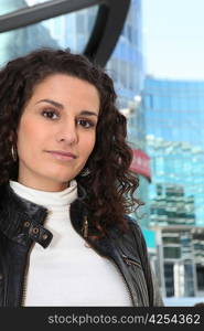 Uncertain woman standing in front of a modern building