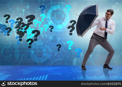Uncertainty concept with businessman and question marks