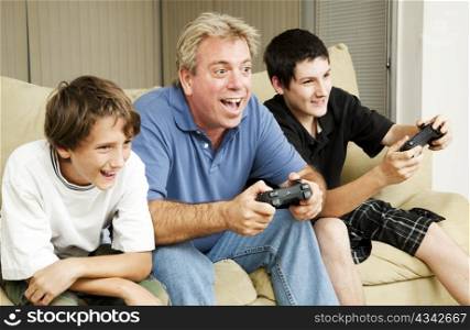 Uncle plays video games with his nephews. Could also be father.