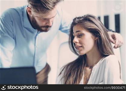 Uncomfortable scared young woman being harassed by her boss at office. Sexual harassment at work, women rights concept.. Businessman Sexually Harassing Female Colleague