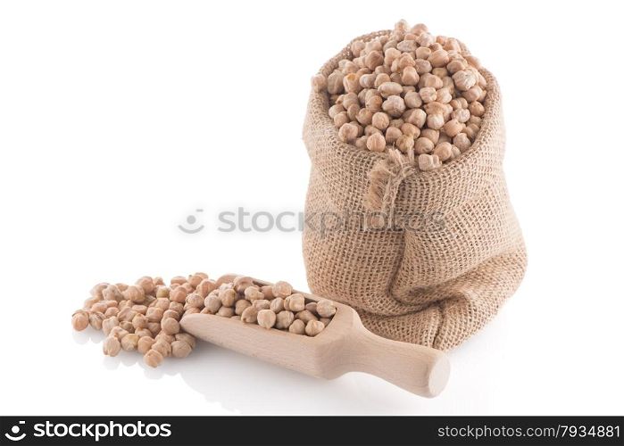 Uncooked chickpeas and wooden scoop on white background.