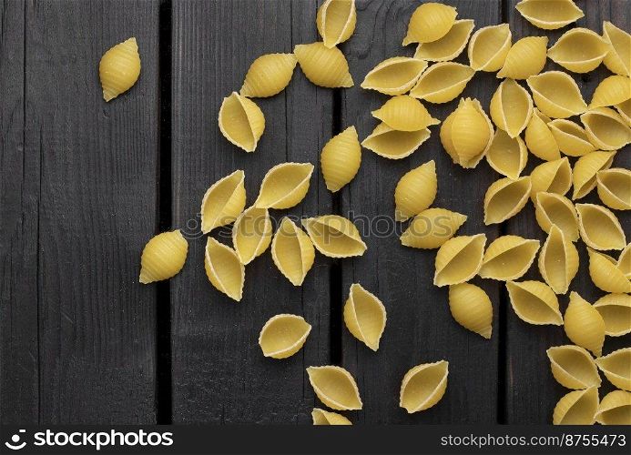 Uncooked conchiglie pasta. Top view of bright background image.