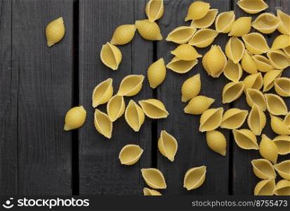 Uncooked conchiglie pasta. Top view of bright background image.