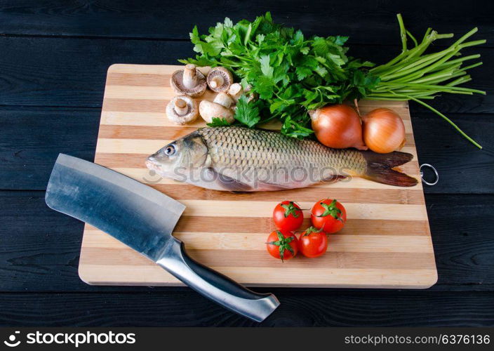 Uncooked fish on cutting board in meal preparation concept