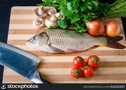 Uncooked fish on cutting board in meal preparation concept