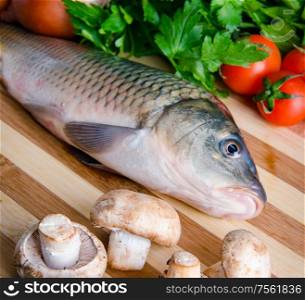 Uncooked fish on cutting board in meal preparation concept. The uncooked fish on cutting board in meal preparation concept