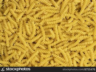 Uncooked gyrandole pasta. Top view of bright background image.