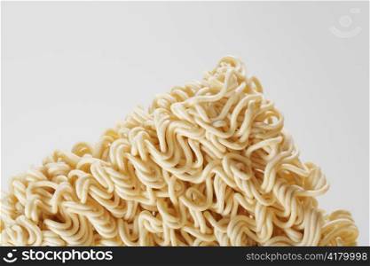 uncooked instant ramen noodles on grey background