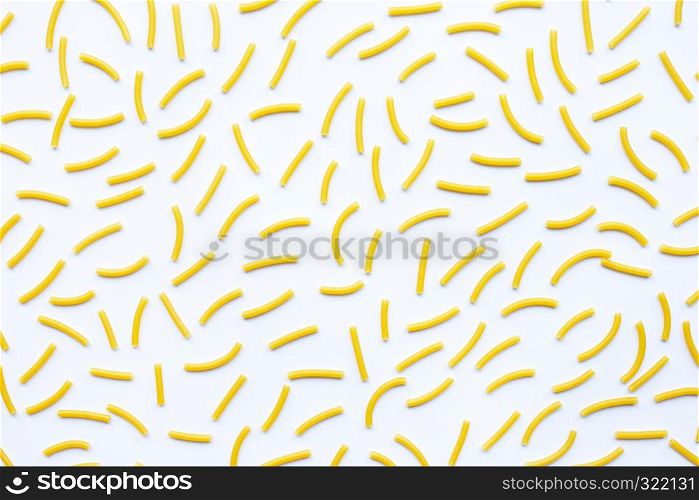 Uncooked macaroni on a white white background.