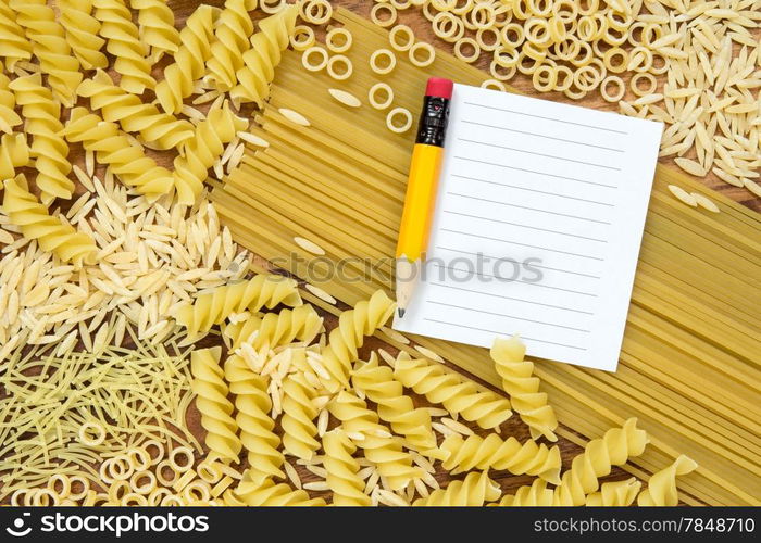 Uncooked pasta and blank paper for recipe