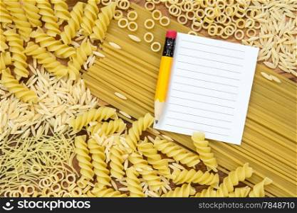Uncooked pasta and blank paper for recipe